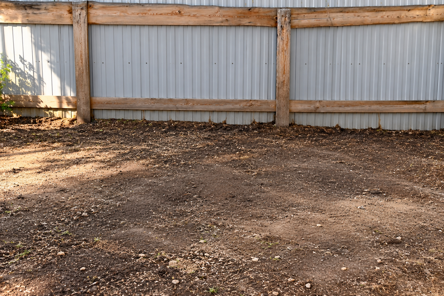Cleared Yard Beside Corrugated Fence